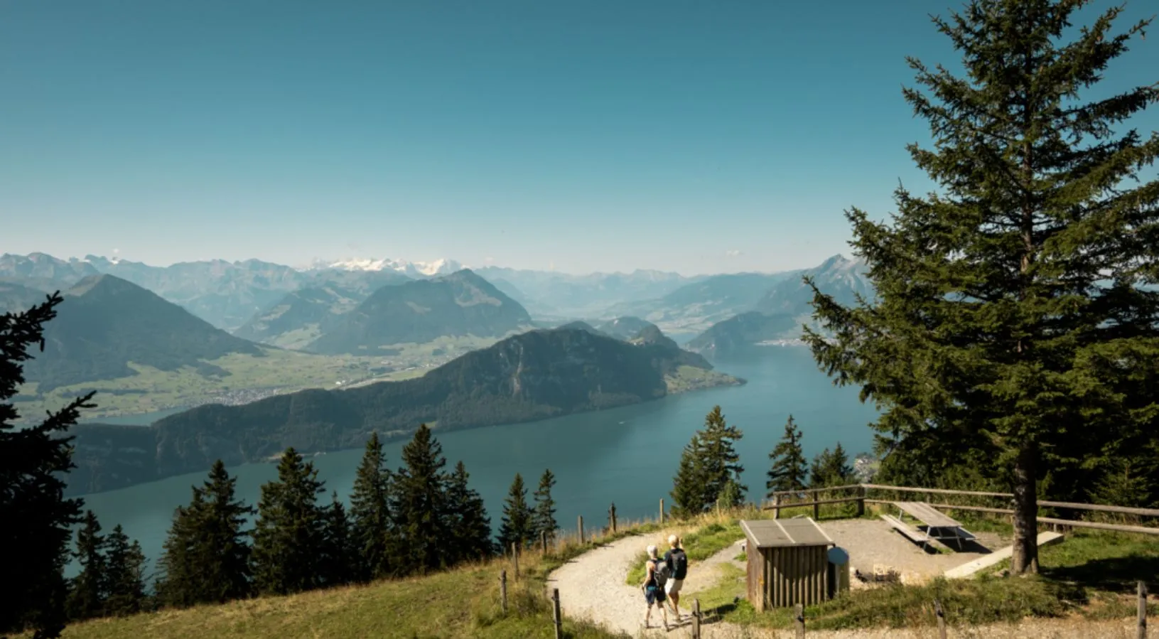 Two hikers going through the hiking route of Mount Rigi.